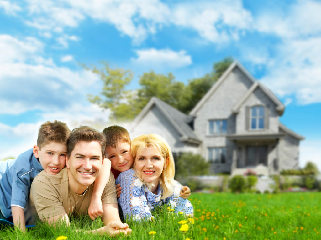 Happy family near new home. Mortgage concept.